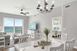 Relax in this spacious living area with a large dining table and ocean views.