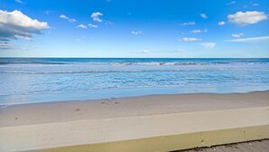 A beach with clear skies and gentle waves. - Spectacular direct ocean front condo with amazing views of the Atlantic (Satellite Beach)