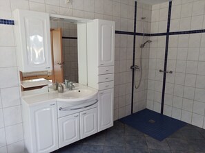 Chuveiro, secador de cabelo, toalhas de banho, sabonete