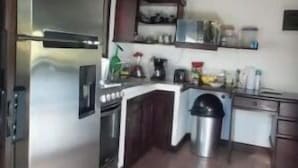 A kitchen with a refrigerator, stove, sink, and cabinets. - Massai Apartments - Standard Suite (Playa Flamingo)