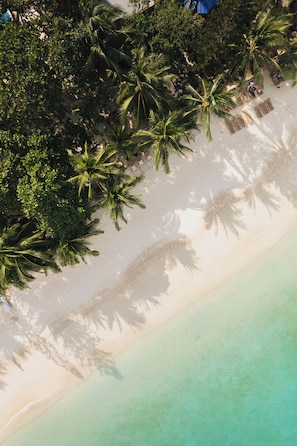 On the beach, white sand, sun loungers, beach towels
