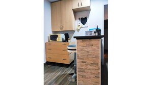 A kitchen with wooden cabinets, a microwave, a coffee maker, and a bar counter with bottles. - Cozy two bedrooms apartment with terrace (Madrid)