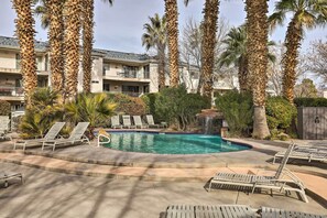 Relax by the pool surrounded by palm trees and modern architecture.