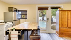 A kitchen with a wooden table, a built-in oven, and a refrigerator. - Mt Dora Couple's Retreat w/ Shared Pool! (Mt Dora)