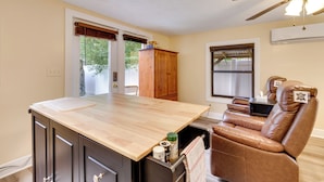 A kitchen with a wooden island, a built-in oven, and a ceiling fan. - Mt Dora Couple's Retreat w/ Shared Pool! (Mt Dora)