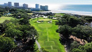 Golfers can enjoy a scenic game surrounded by lush greenery and ocean views.