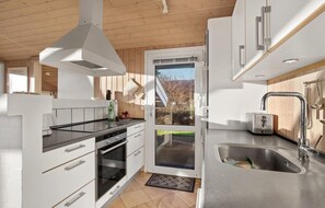 Enjoy cooking in this well-equipped kitchen with an oven, range hood, and dishwasher.