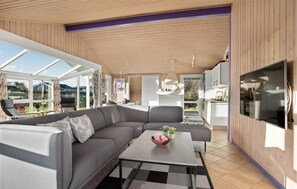 Relax in this spacious living area with a large sectional sofa and flat-screen TV.