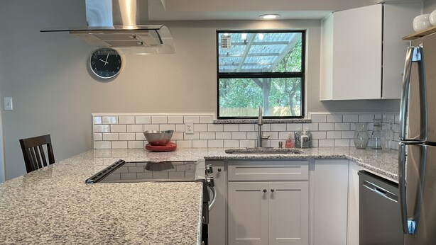 A modern kitchen with granite countertops, stainless steel appliances, and white cabinetry. - Entire House - 5 Minutes Drive to AT&T Stadium (Arlington)