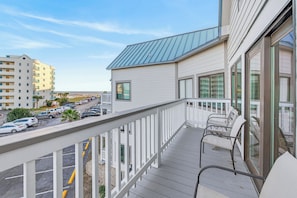 A balcony with a view of a parking lot and buildings. - Gulf Shores Plantation-West 1353 (Gulf Shores)