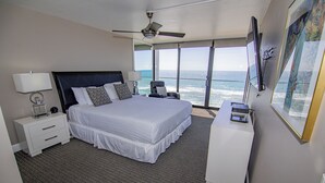 A modern hotel room with a large bed, a desk, and a view of the ocean. - TWO BEDROOM CONDO 708 (San Diego)