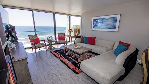 A living room with a sofa, chairs, a coffee table, and a view of the ocean. - TWO BEDROOM CONDO 708 (San Diego)
