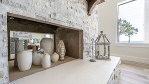 A stone fireplace with decorative vases and a lantern.