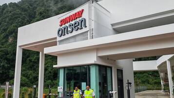 A modern building with a sign reading "SUNWAY onsen".