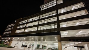 Un edificio de varios pisos con un acceso cubierto y un letrero que dice 'NO ENTRY'.