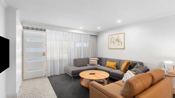 Deluxe Apartment | Living area | 58-inch Smart TV with cable channels, TV