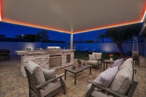 Relax outdoors with a barbecue station and comfortable seating area.