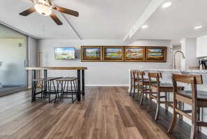 Enjoy meals in the kitchen with an oven and dining area featuring a wooden table and chairs.