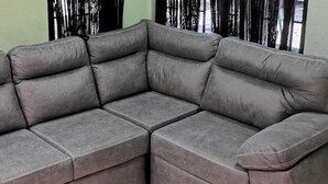 A grey sectional sofa in a room with a green wall and black curtains. - Casa Zury Playa (QUEPOS)