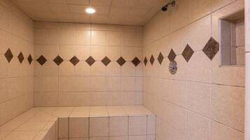 Enjoy a refreshing shower experience with a bench for comfort.