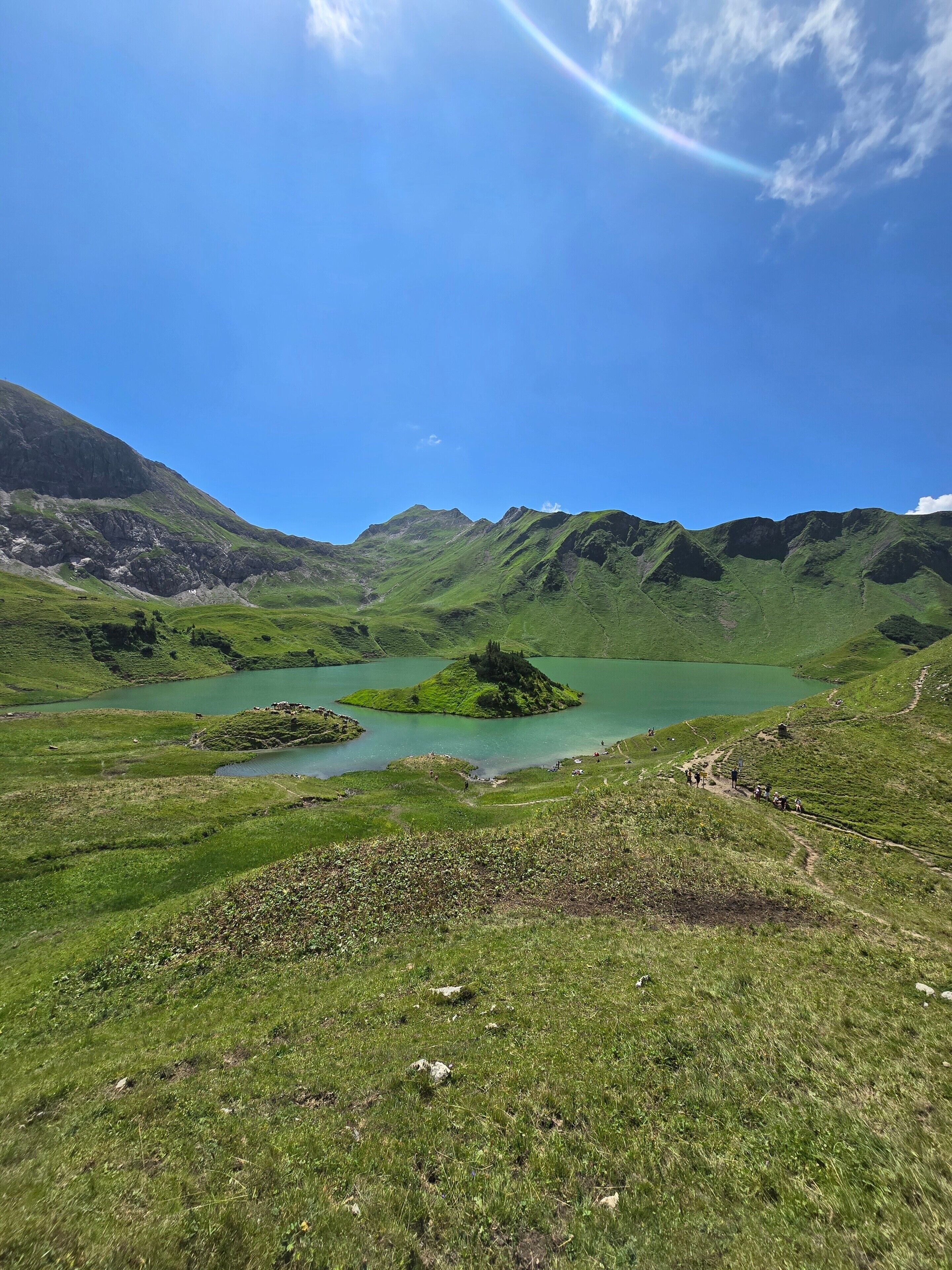 A mountainous landscape with a lake and a clear sky.