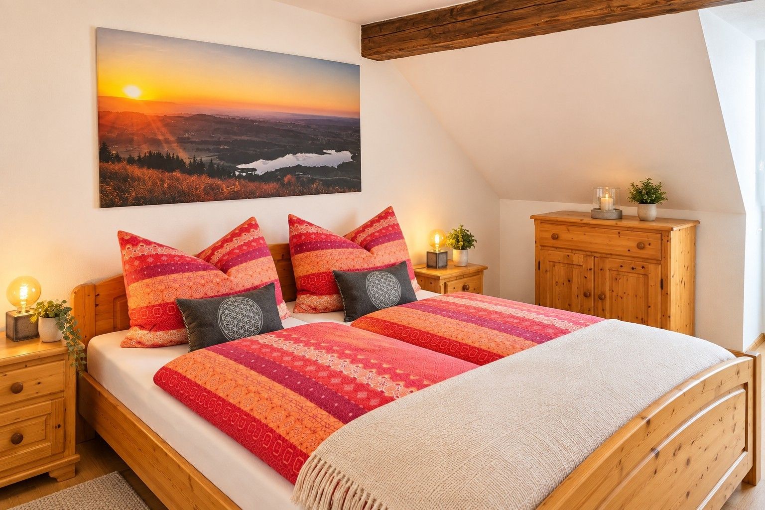 A bedroom with a large bed, wooden headboard, a nightstand with a lamp, a dresser, and a painting of a landscape.