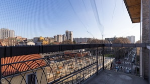 A balcony with a view of a cityscape, including buildings and a parking lot. - Risorgimento 99 A in Sesto San Giovanni (Sesto San Giovanni)