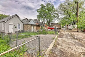 Houses with various architectural styles stand amidst a tranquil tree-lined setting.