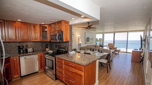 A spacious kitchen with wooden cabinets, stainless steel appliances, and a large island.