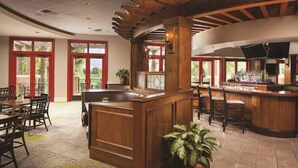 A spacious lobby with a wooden reception desk, multiple seating areas, and large windows offering views of the outdoors. - Marriott's Shadow Ridge II (Palm Desert)