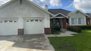A two-story house with a garage, a front porch, and a well-maintained lawn. - Beautiful peaceful desirable home in Madera Rancho (Madera)