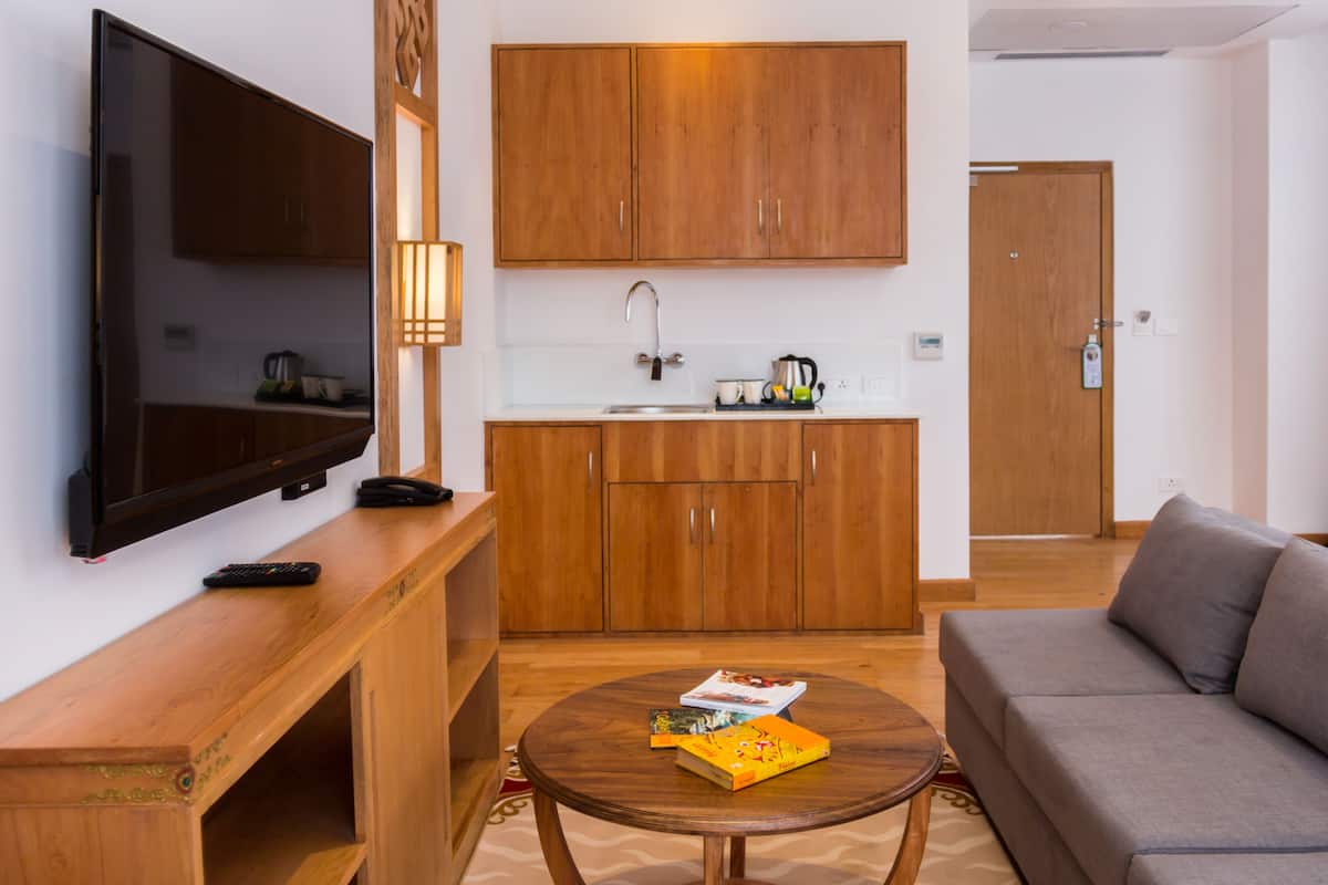 Luxury Suite | Living area | 45-inch LED TV with cable channels, TV