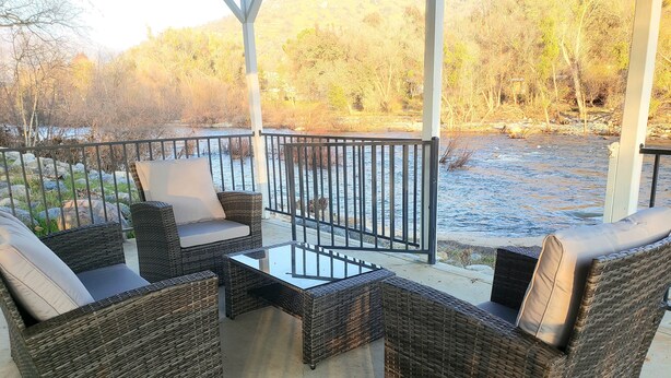 A covered outdoor seating area with wicker furniture and a glass table. - Oasis Riverfront House - Gazebo overlooks the River, 5 miles to Sequoia SNP gate (Three Rivers)