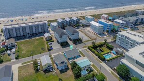 A coastal hotel with multiple buildings, a beach, and a swimming pool. - Beachwood Bungalow B, walk to beach and boardwalk (Carolina Beach)