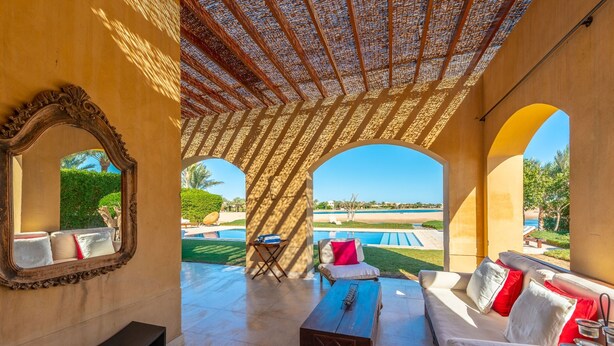 A sunlit patio with a pool, outdoor seating, and a view of the pool area. - VESTA - Superior Villa - 3BR - North Golf I (Hurghada)