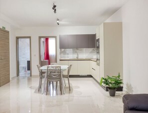 A modern kitchen with a marble countertop, a built-in oven, and a sink. - 5th Floor brand new APT, with PRVT Balcony & WIFI (Il-Gżira)