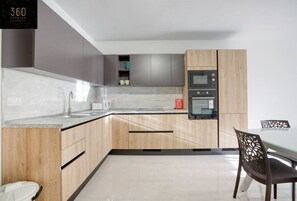 Enjoy cooking in this well-equipped kitchen with an oven, microwave, and coffee machine.
