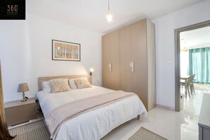 1 bedroom, desk, iron/ironing board, travel crib