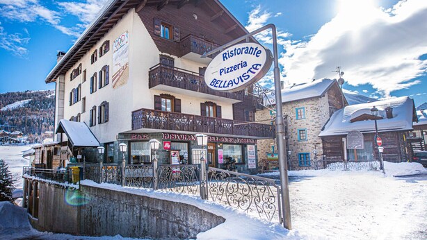 A building with a sign for 'Ristorante Bellavista' and a 'Bar' sign below it. - Autonomy, but also comfort? Residence Livigno is the one for you! (Livigno)