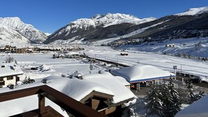 A snow-covered mountain town with buildings and a ski lift. - Autonomy, but also comfort? Residence Livigno is the one for you! (Livigno)