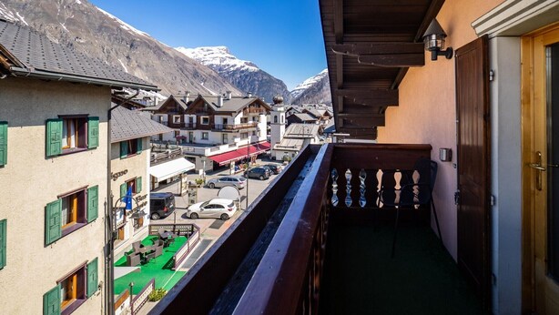 A balcony with a view of a mountain and a town. - Your next stay in Livigno without giving up anything! (Livigno)