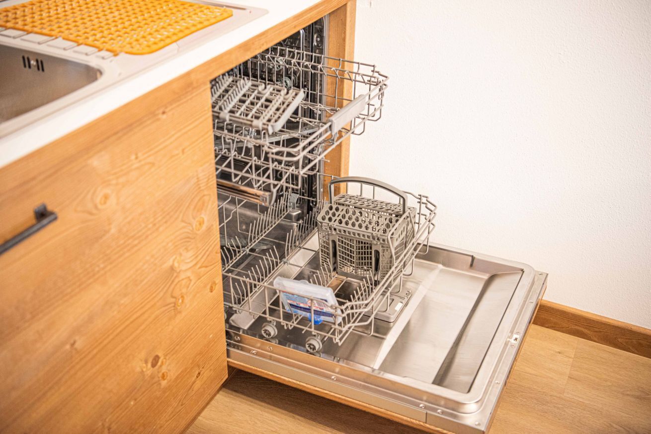 A dishwasher in a kitchen cabinet.