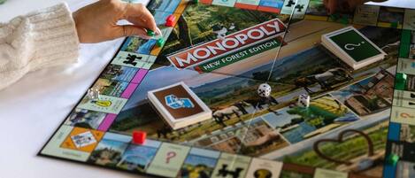 A Monopoly board game with various property cards and money.