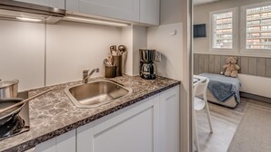 A modern kitchen with a marble countertop, stainless steel sink, and a coffee maker. - PREMIUM Studio in Tignes, 2 people, WIFI included (Tignes)