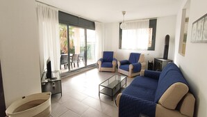 A living room with a sofa, armchairs, a coffee table, and a dining area with a table and chairs. - Villa with Private Pool, 100m from Sea, Spacious Garden, Near Calafat in Costa Dorada (L'Ametlla de Mar)