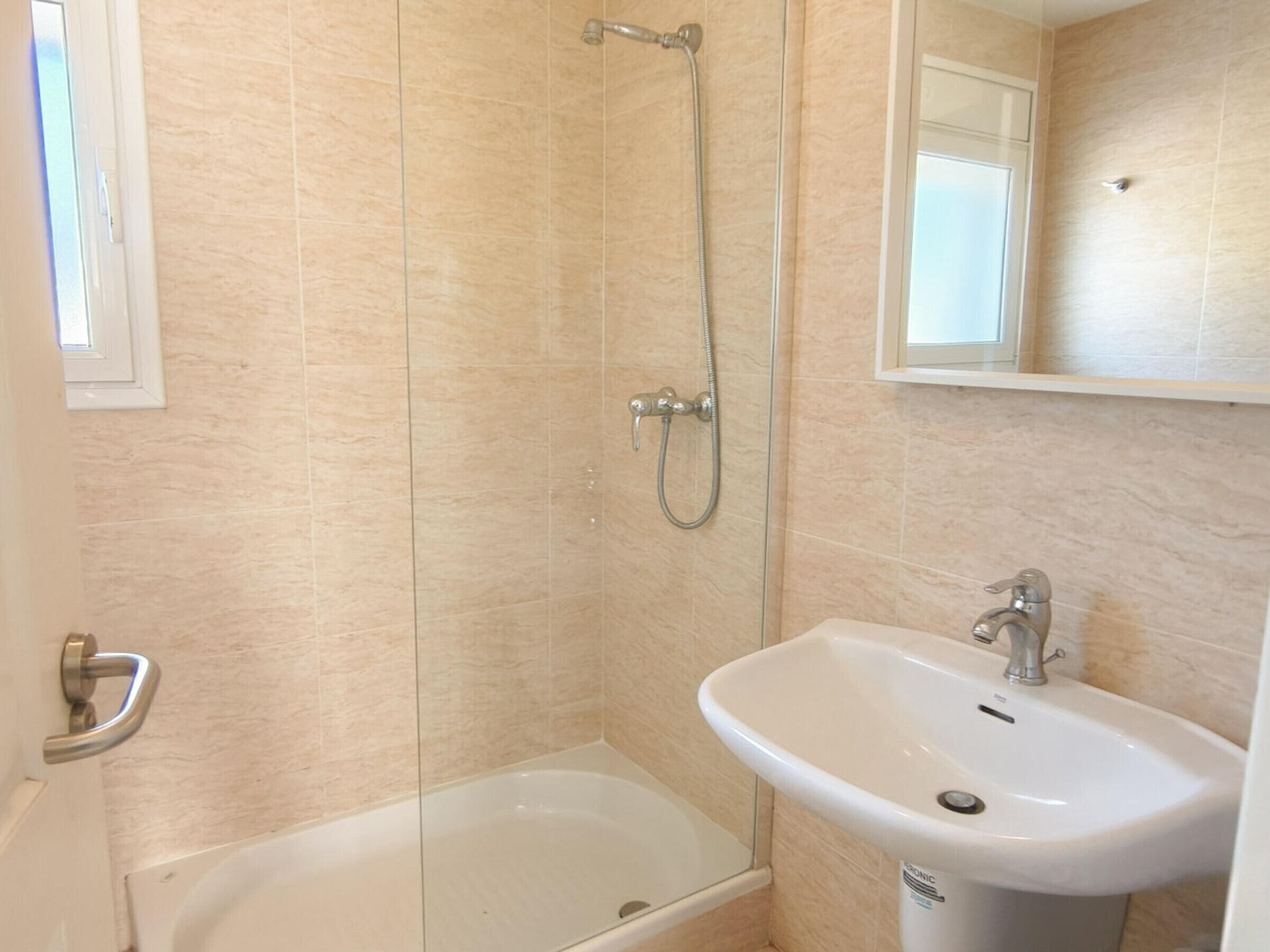 Une salle de bain avec une baignoire, une douche et un lavabo.
