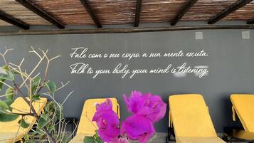 Relax in a serene space with lounge chairs and a calming quote.