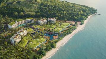 A resort with multiple buildings, a golf course, and a beach.