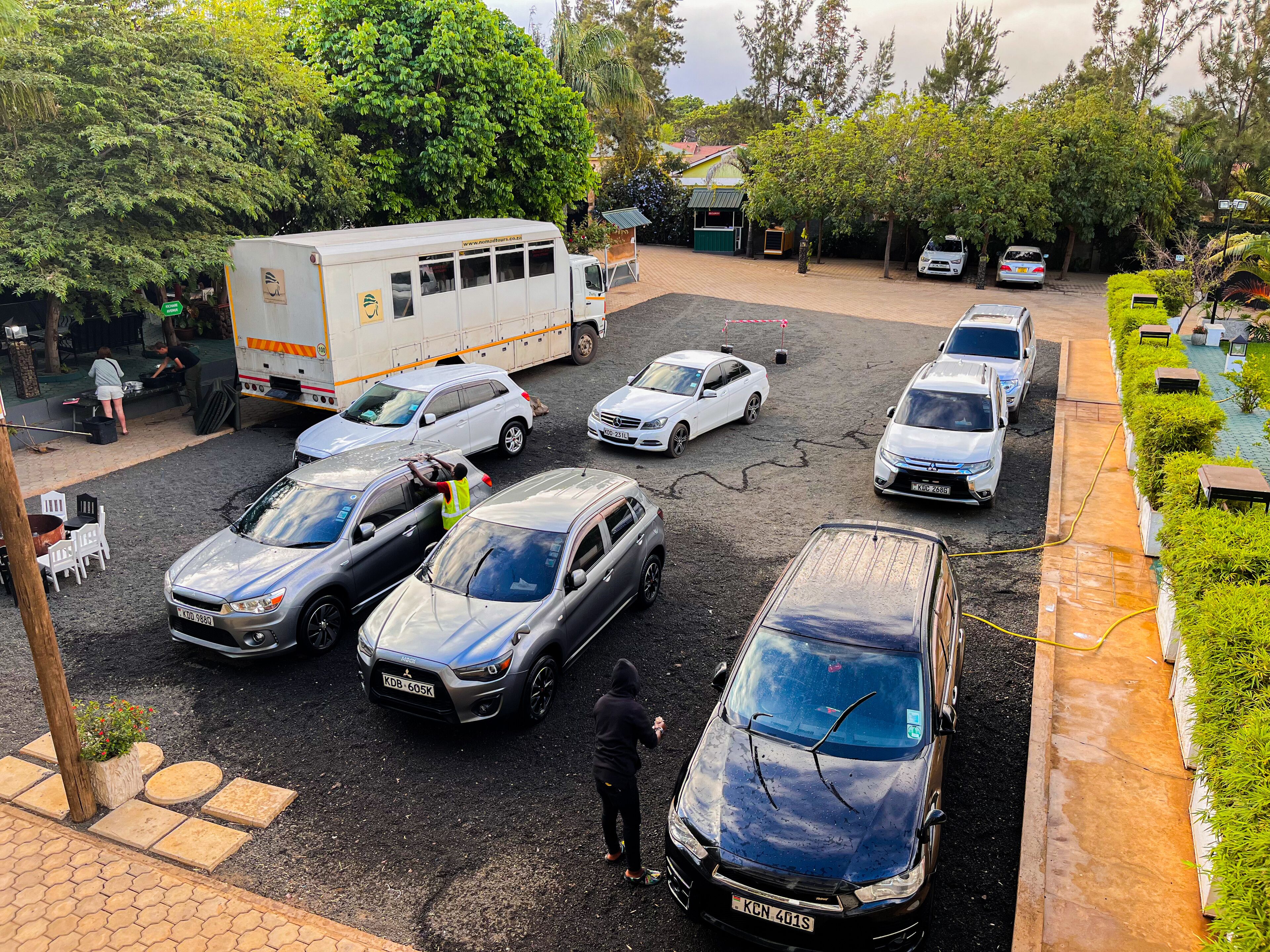 A parking lot with multiple cars and a white truck.