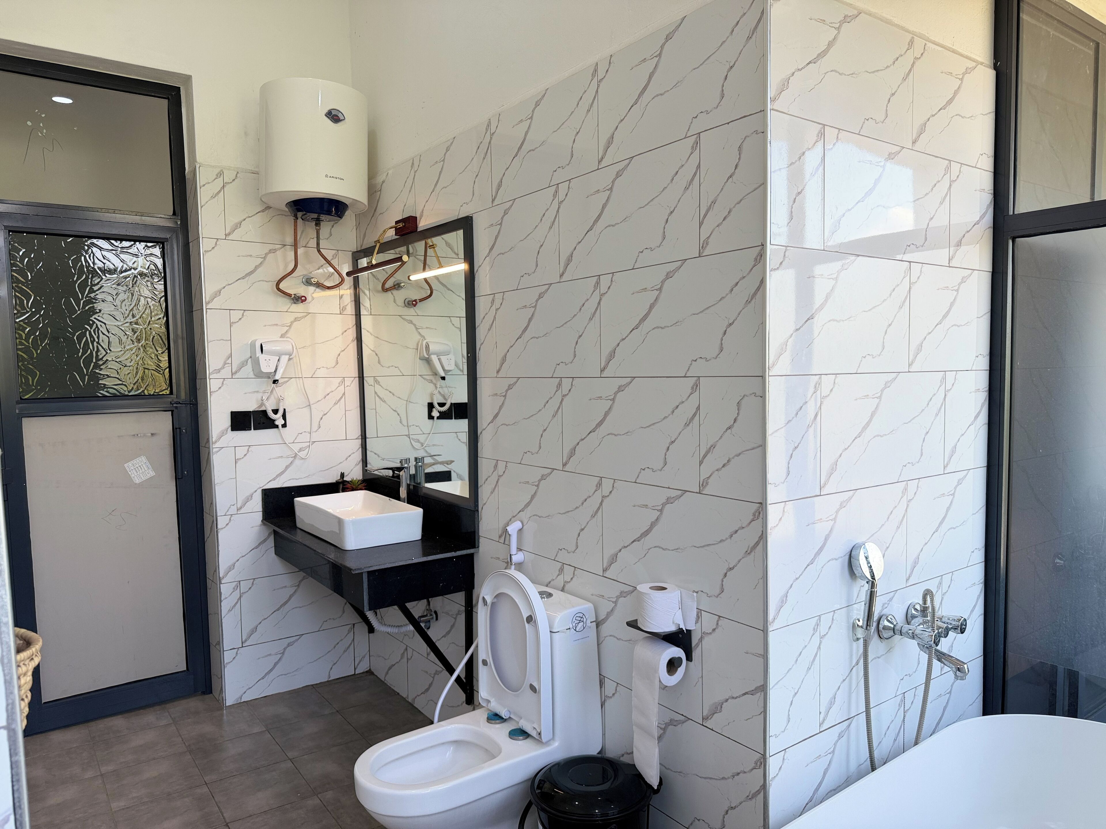 A modern bathroom with a toilet, bidet, and sink.